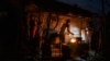 La familia Ramos prepara la cena en el fuego afuera de su casa dañada por el huracán Ian en La Coloma, provincia de Pinar del Río, Cuba, el 5 de octubre de 2022. (AP Foto/Ramón Espinosa)
