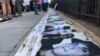 Los rostros de los presos del 11J, en una vigilia por el aniversario de las protestas, en Washington, DC.