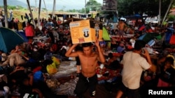 Migrantes hacen una parada para descansar antes de continuar su camino hacia la frontera con Estados Unidos, en Huixtla, México, el 6 de noviembre de 2024.