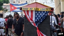 Un bicitaxi con la bandera estadounidense transporta turistas en La Habana.