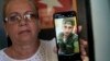 Marilin Vinent holds up a photo of her son Dannys Castillo, uno de los cubanos reclutados para luchar por Rusia en Ucrania. (Foto AP/Ramón Espinosa)