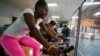 Las ex integrantes del equipo cubano de hockey Lismary González, al frente, y Yunia Milanés, que participaron en los Juegos Panamericanos, entrenan con otros atletas cubanos en el gimnasio municipal de Lo Barnechea. Santiago, Chile, el 10 de noviembre de 2023. (AP/Esteban Félix)
