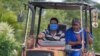Dos cubanos viajan el martes en tractor por una calle de La Habana (Yamil Lage/AFP).
