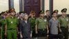 el activista Luu Van Vinh (izq.) y otros acusados comparecen ante el tribunal en la ciudad de Ho Chi Minh, el 5 de octubre de 2018.